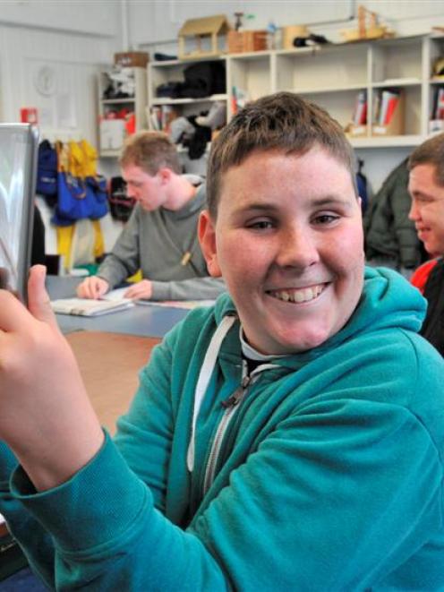 Sara Cohen School pupil Joshua Anderson (18) acquaints himself with a new iPad mini, one of five...