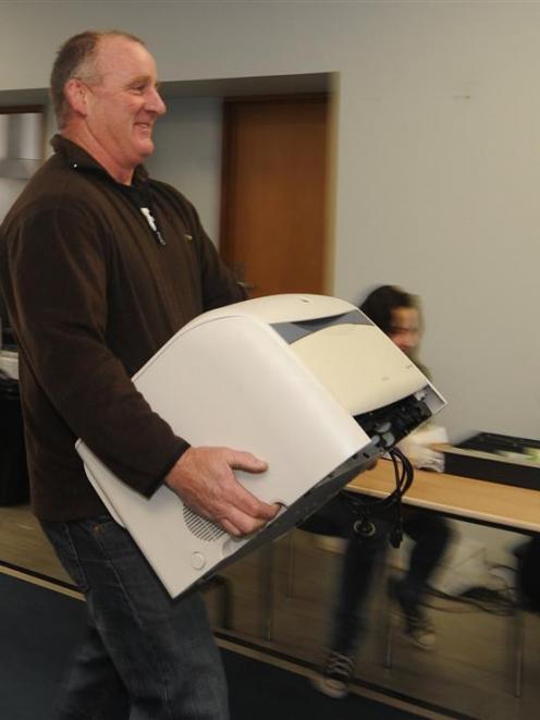 Satisfied bargain hunter Dunedin resident Michael Todd carries away a photocopier bought at the...