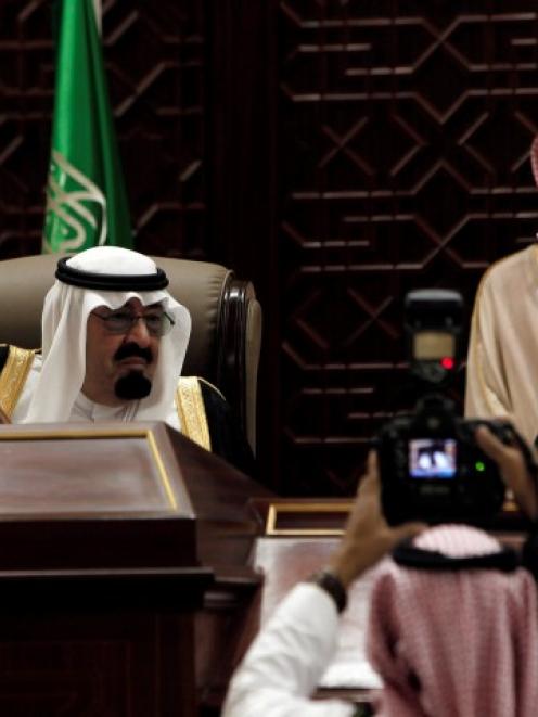 Saudi King Abdullah bin Abdulaziz al-Saud (seated on L) attends a Shura assembly in Riyadh...