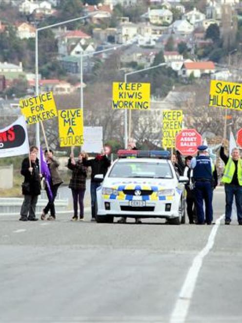 Save Hillside protesters are kept back by police during the opening of State Highway 88 in...