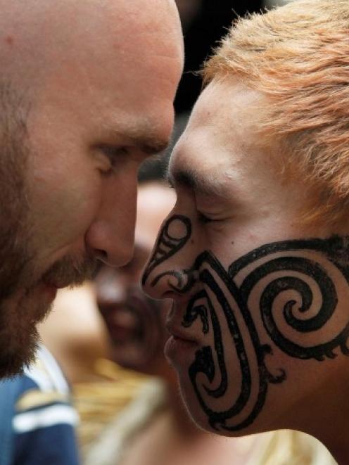 Scotland's Ally Strokosch (L) exchanges a hongi with a local after arriving at Invercargill...