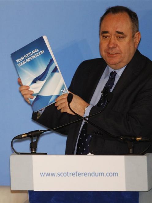 Scotland's First Minister Alex Salmond (right) holds a copy of the plans for consultation for a...