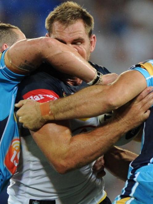 Scott Bolton of the Cowboys is caught by the Titans defence. Photo by Matt Roberts/Getty Images