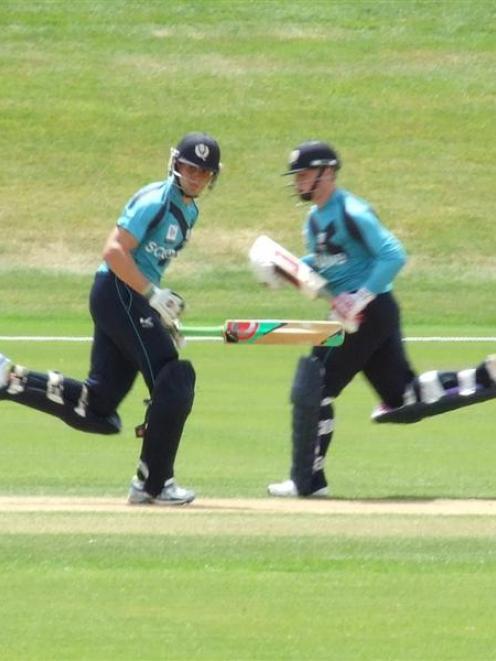 Scottish batsmen Matt Machan and Calum MacLeod scamper through for a run during their team's...