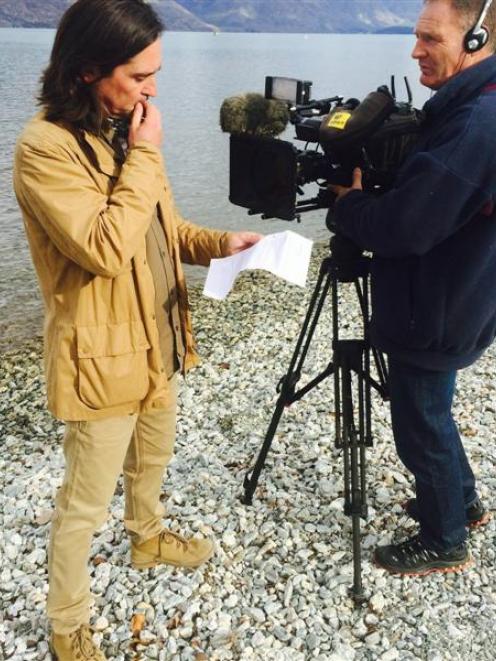 Scottish television personality Neil Oliver films with cameraman Jeff Aldridge on the Queenstown...