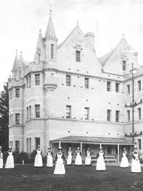 Seacliff Lunatic Asylum nursing staff pose on the lawn in front of the building, c 1890, in this...
