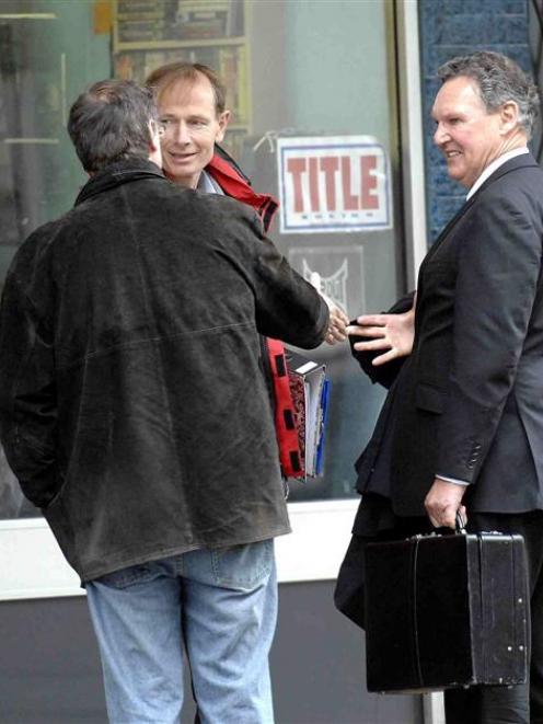 Sean Davison (centre) with his lawyer and a supporter after leaving the High Court in Dunedin today.