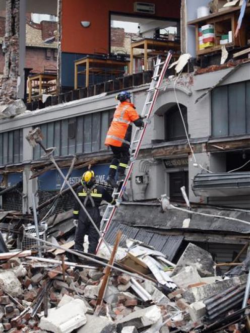 Search and rescue teams work to secure a building on the corner of Worcester and Manchester Sts...