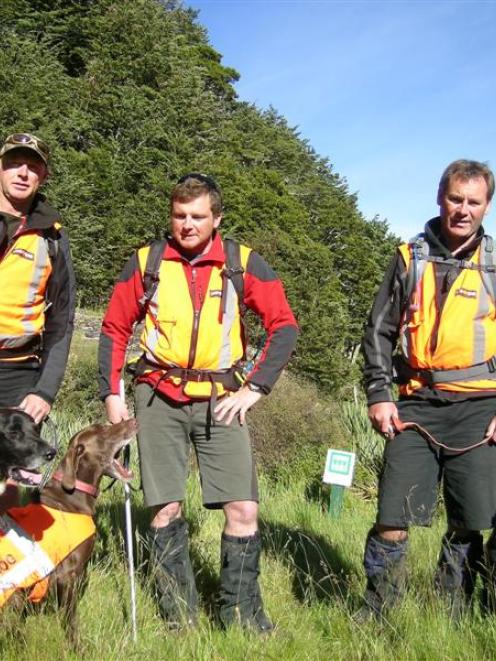 Search dog team (from left) Mark Allen, of Twizel, Dave Krehic, of Christchurch, and Brent...