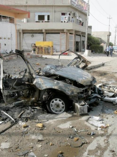 Security personnel inspect the site of a car bomb attack in Kirkuk, 250km north of Baghdad....