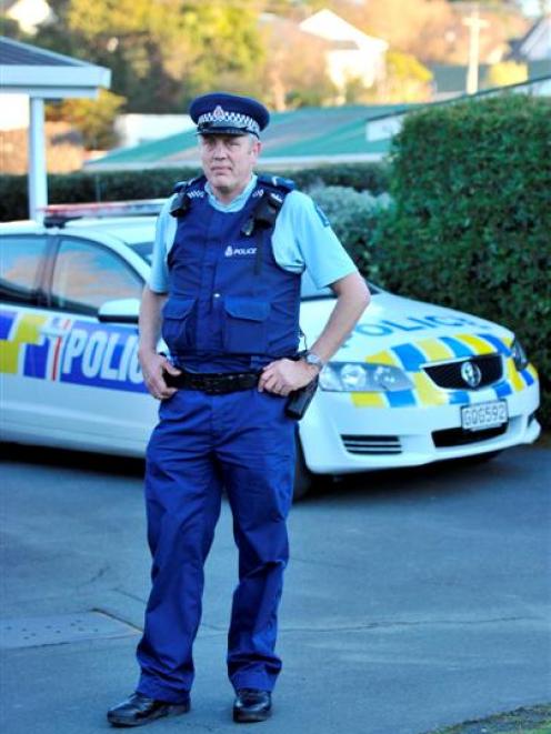 Senior constable Fred Jansen models the new trousers he is trialling outside the Green Island...