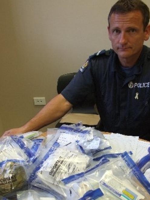 Senior Constable Graeme McPherson with some of the prescription medication seized by police...
