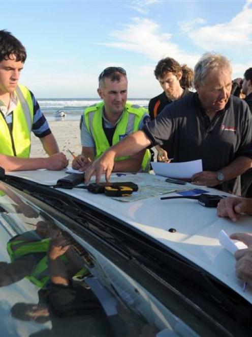 Senior Constable Lox Kellas (arm extended) co-ordinates the operation.