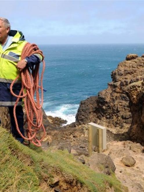 Senior Constable Lox Kellas, of Portobello, with part of the newly-installed life ring casing...