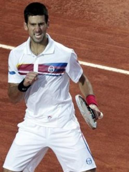 Serbia's Novak Djokovic reacts after winning a point against Spain's Rafael Nadal during the...