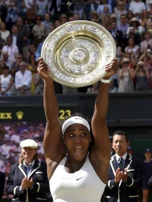 Serena Williams lifts the trophy after her victory over Garbine Muguruza. REUTERS/Toby Melville