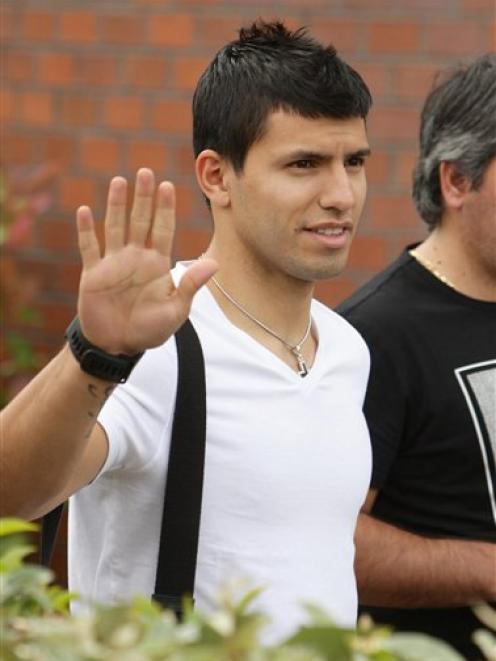 Sergio Aguero gestures as he leaves the Bridgewater Hospital following his medical ahead of...