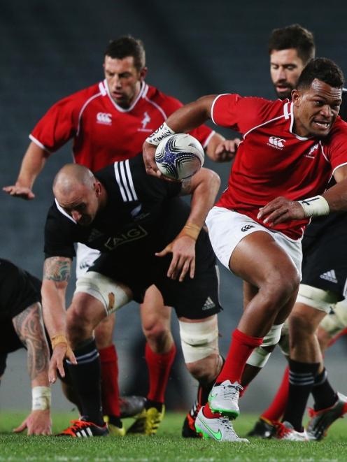Seta Tamanivalu makes a break for the New Zealand Barbarians against the Maori All Blacks. Photo...