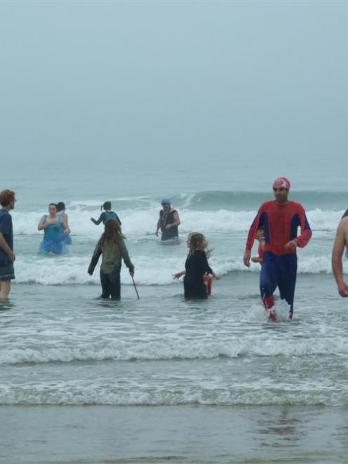 Shane Gregory, of Kaka Point, (second from right) found the Kaka Point Surf Lifesaving Club's...