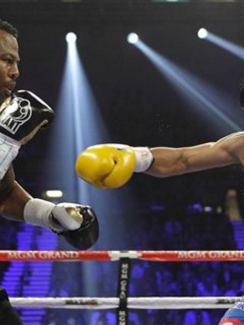 Shane Mosley, left, and Manny Pacquiao exchange punches in the second round during a WBO...