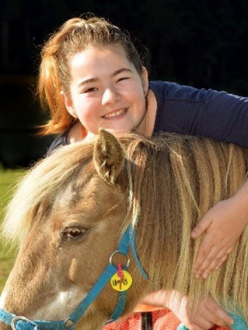 Shania Hutton gets close to Honey, at Riding for the Disabled, where she is a volunteer. Photo...