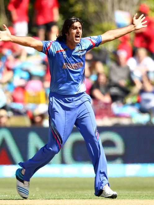 Shapoor Zadran of Afghanistan celebrates a wicket during the 2015 ICC Cricket World Cup match...