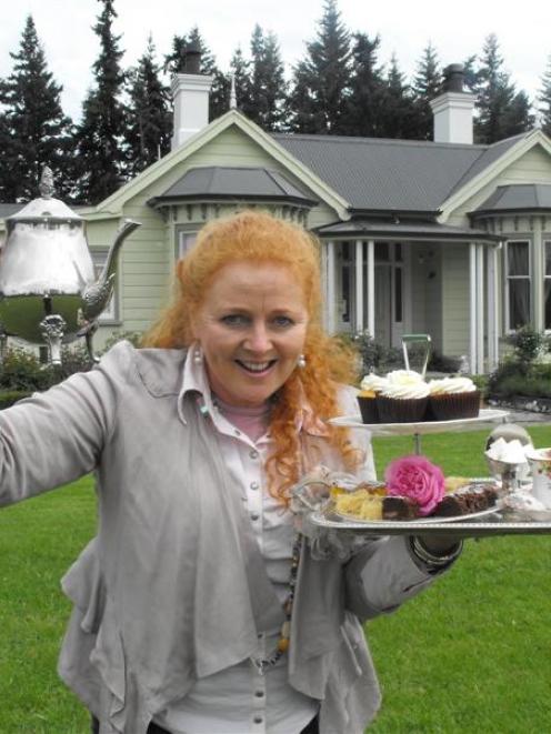 Sheena Haywood stands outside her Laurel Bank House home with treats that will be available at...
