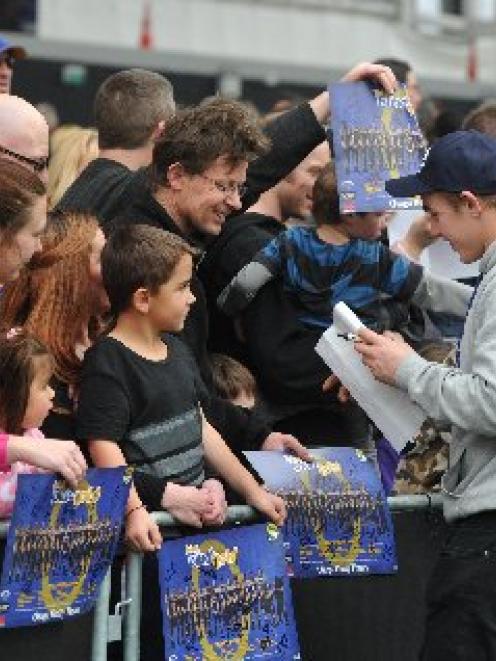 Shield hero Hayden Parker signs autographs at Forsyth Barr Stadium yesterday. Photo by Craig Baxter.