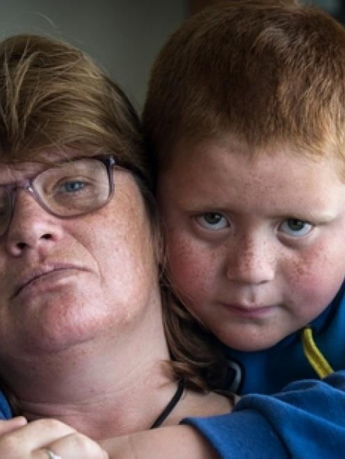 Shona Maiden, with son Johnny (7) says she lost five teeth in the attack. Photo: NZ Herald