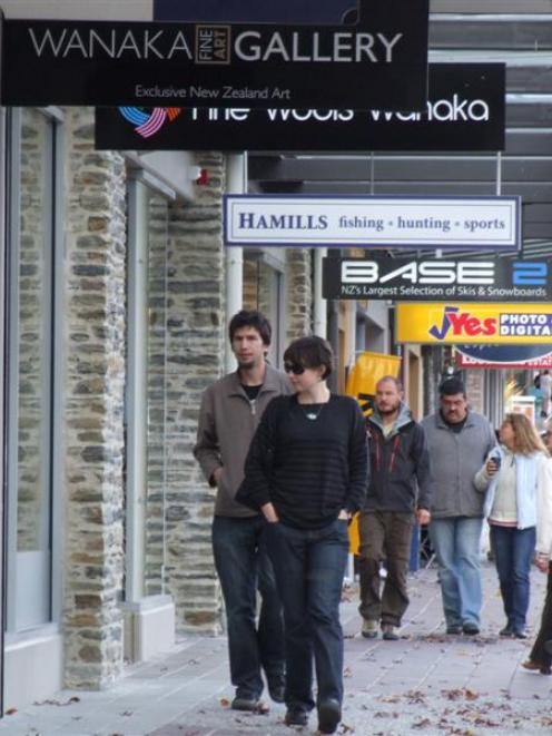 Shoppers browse in the main retail area in Wanaka, yesterday, where about half  Helwick St's...
