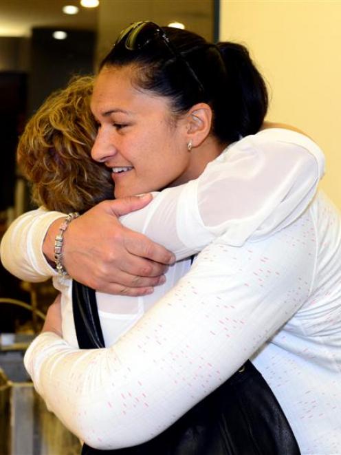 Shot put champion Valerie Adams and New Zealand team manager Raylene Bates hug in Dunedin...