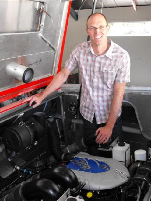 Shotover Jet boat maintenance manager Brett Dingle beside the new V8 Mercruiser engines the...