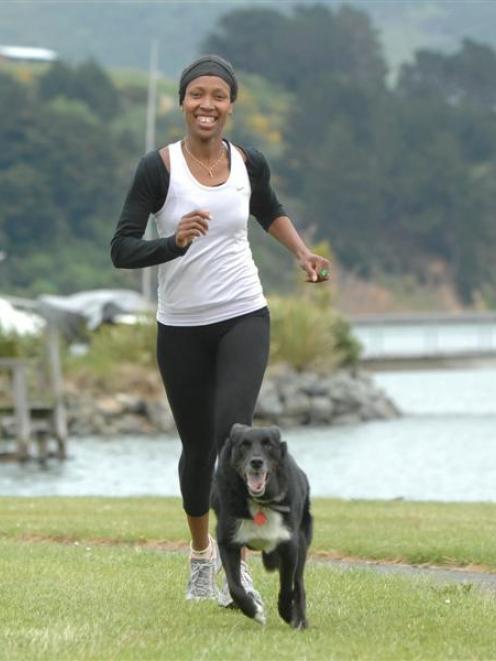 Shukuru Munro and her three-legged dog Bart run near their home Broad Bay in preparation for the...