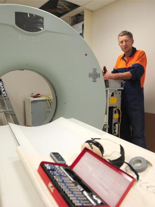 Siemens medical engineer John Milburn installing a new $1 million CT scanner at Otago Radiology,...