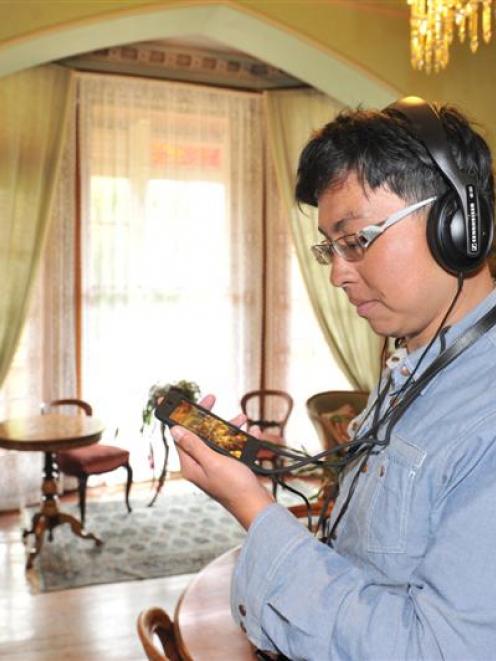 Singapore tourist Nicky Phua explores the Larnach Castle drawing room using  the new app this week.