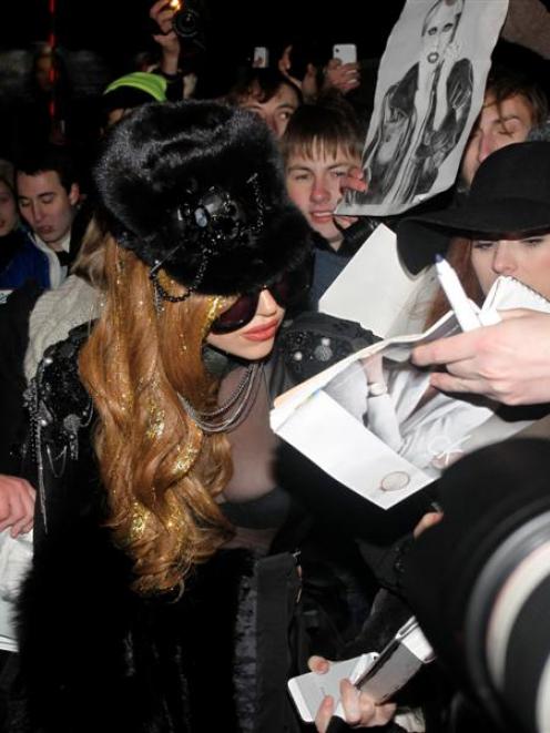 Singer Lady Gaga signs autographs on arrival at Moscow's Vnukovo airport.  REUTERS/Ivan Burnyashev
