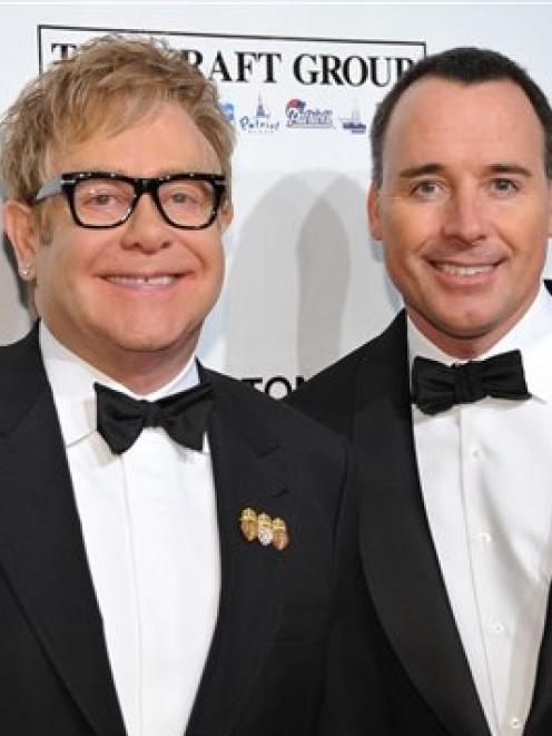 Sir Elton John (left) and husband David Furnish. Photo by AP.