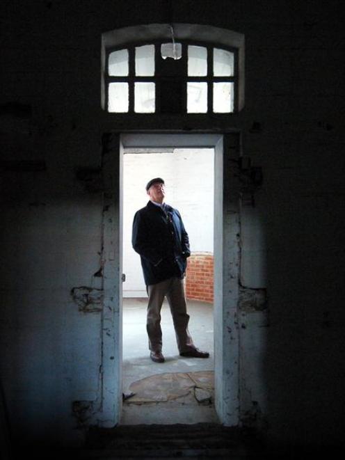 Sir Neil Cossons inspects a cell in the former Dunedin Prison (inset, top right) during a tour...