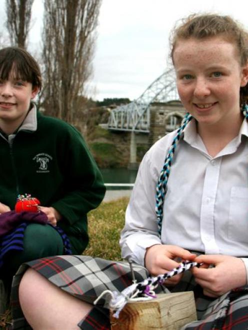 Sisters (from left) Tyla (11) and Brie (13) Davidson, of Alexandra, work with wool and merino...