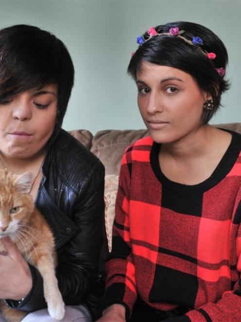 Sisters Milly (left) and Amy Fernando,  at home with Bungle, whose sister Pansy died this week,...