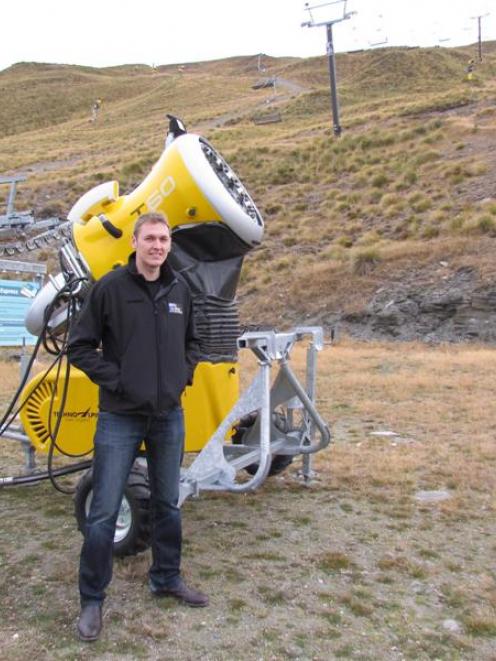 Ski's new Coronet Peak ski area manager Ross Copland with  one of the skifield's snow guns. Photo...