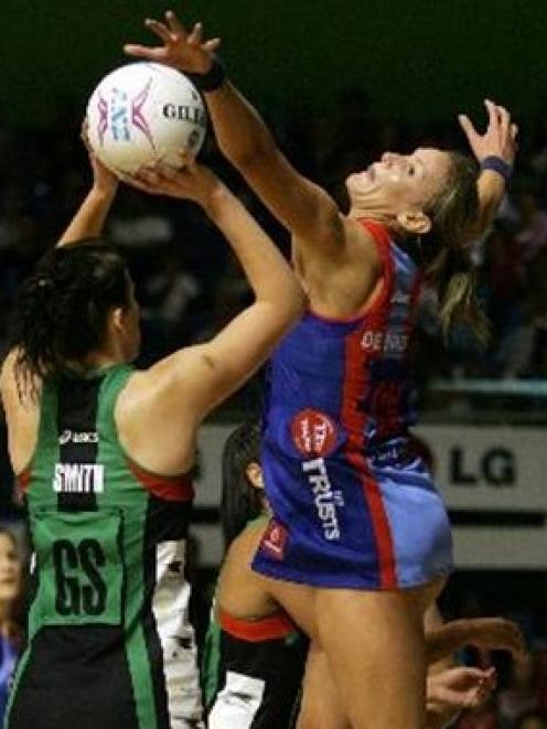 Mystics defender Leana de Bruin (right) stretches out against Nikala Smith, of the Fever, during...