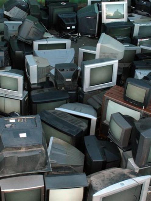 Smiths City Andersons Bay manager Vick Veera is dwarfed by the redundant television sets that...