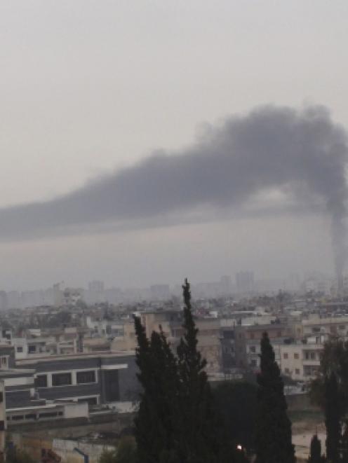 Smoke billows in Homs after Syrian President Bashar al-Assad's forces renewed their bombardment. ...