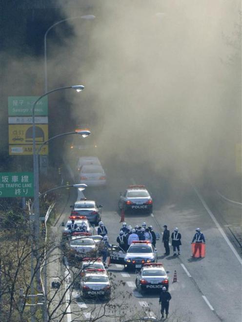 Smoke is seen from the Sasago Tunnel on the Chuo Expressway.  REUTERS/Kyodo