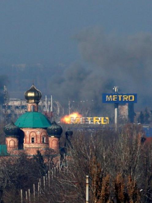Smoke rises above an old terminal (L) and an administrative building of the Sergey Prokofiev...
