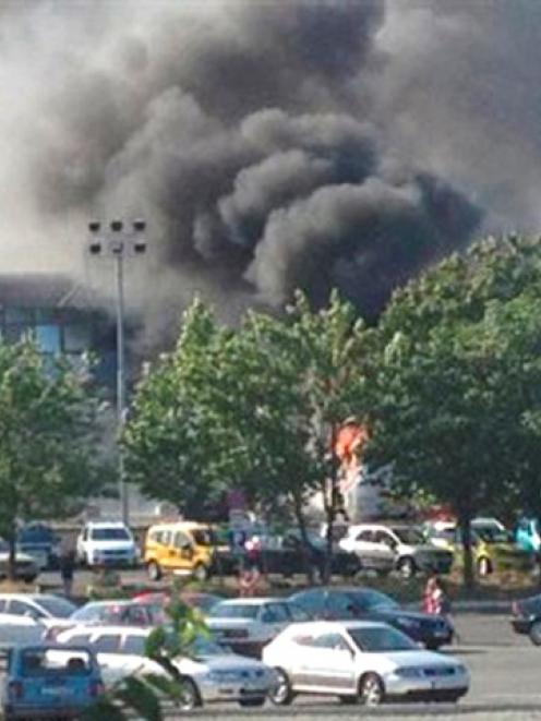 Smoke rises outside Bulgaria's Burgas airport after an explosion on a bus which claimed the lives...