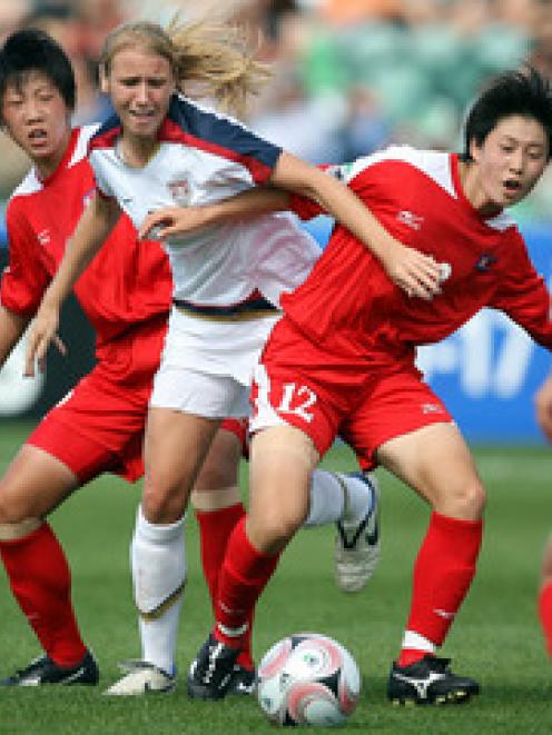 USA's Courtney Verloo is blocked by Korea DPR's KIM Hyon Mi