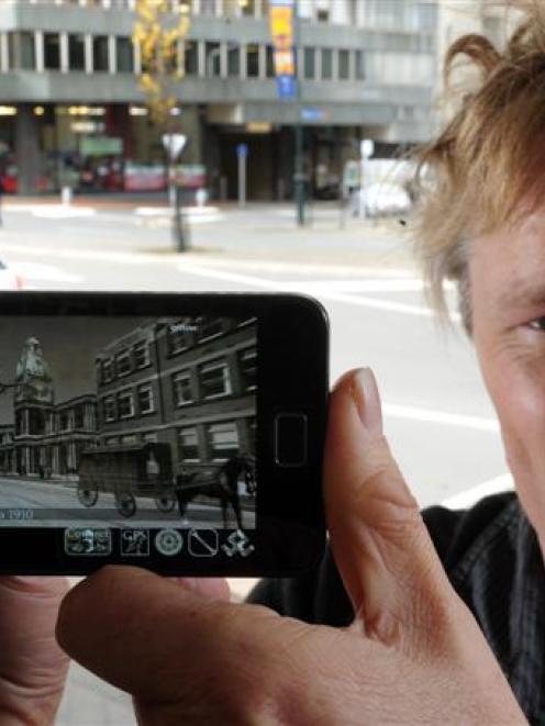 Software developer Glenn Linde displays his Android app, Dunedin, which recreates early 20th...