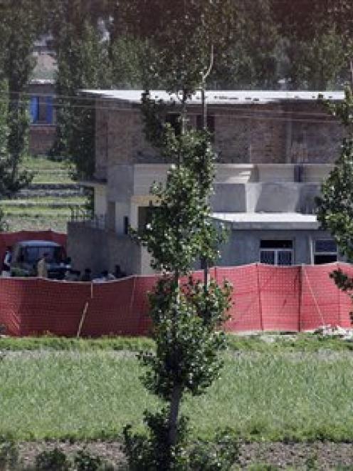 Soldiers from Pakistan's army are seen near the house in Abbottabad, Pakistan, where it is...